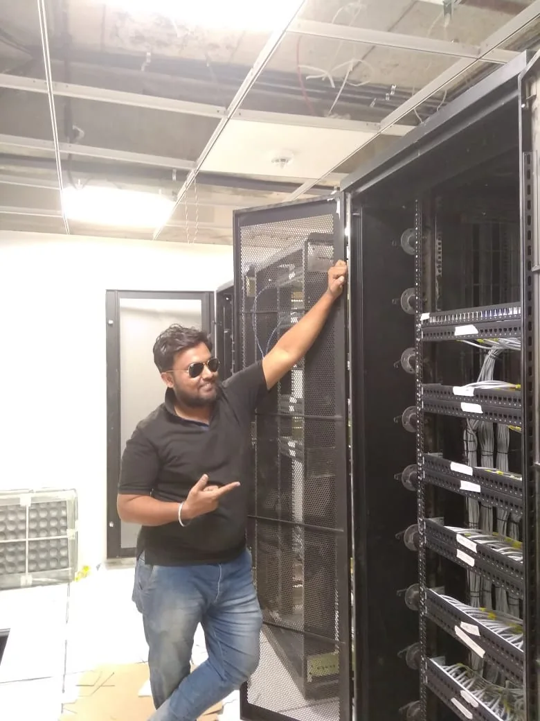 Technician standing near data center racks